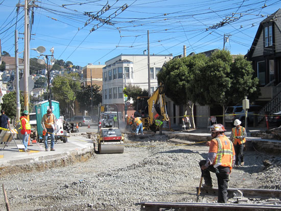 Leveling gravel and preparing to lay the new track.