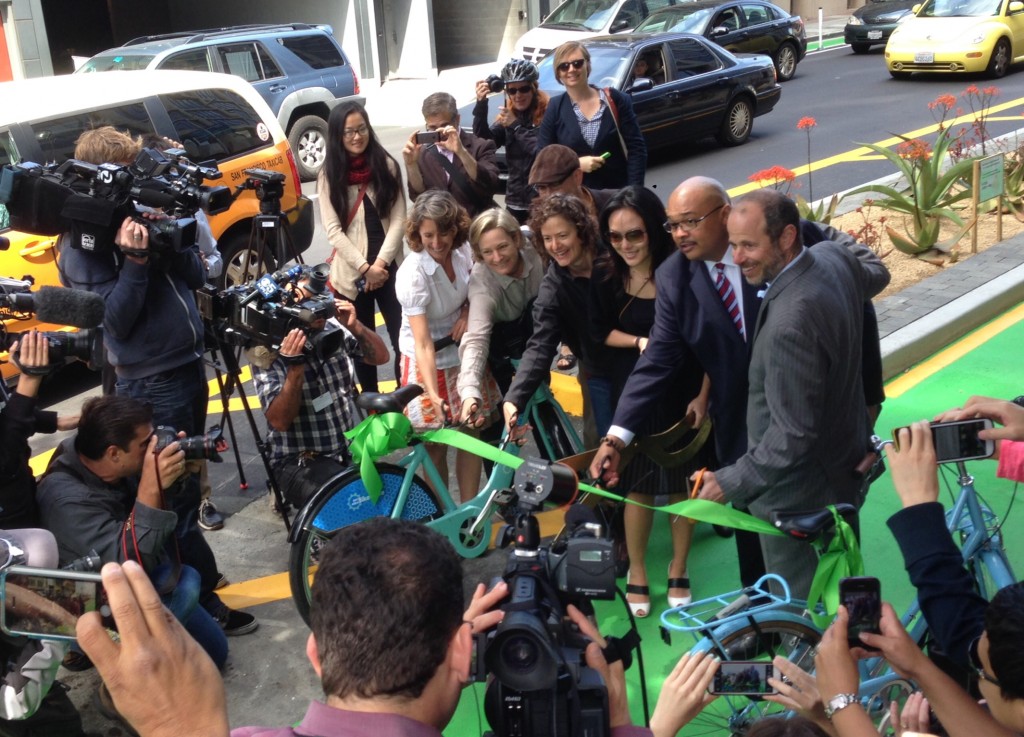 Leah Shahum, Cherylle Brinkman, Shannon Dodge, Supervisor Jane Kim, Mohammed Nuru, and Ed Reiskin pose as they cut the ribbon on the new bikeway. Photo: Stan Parkford