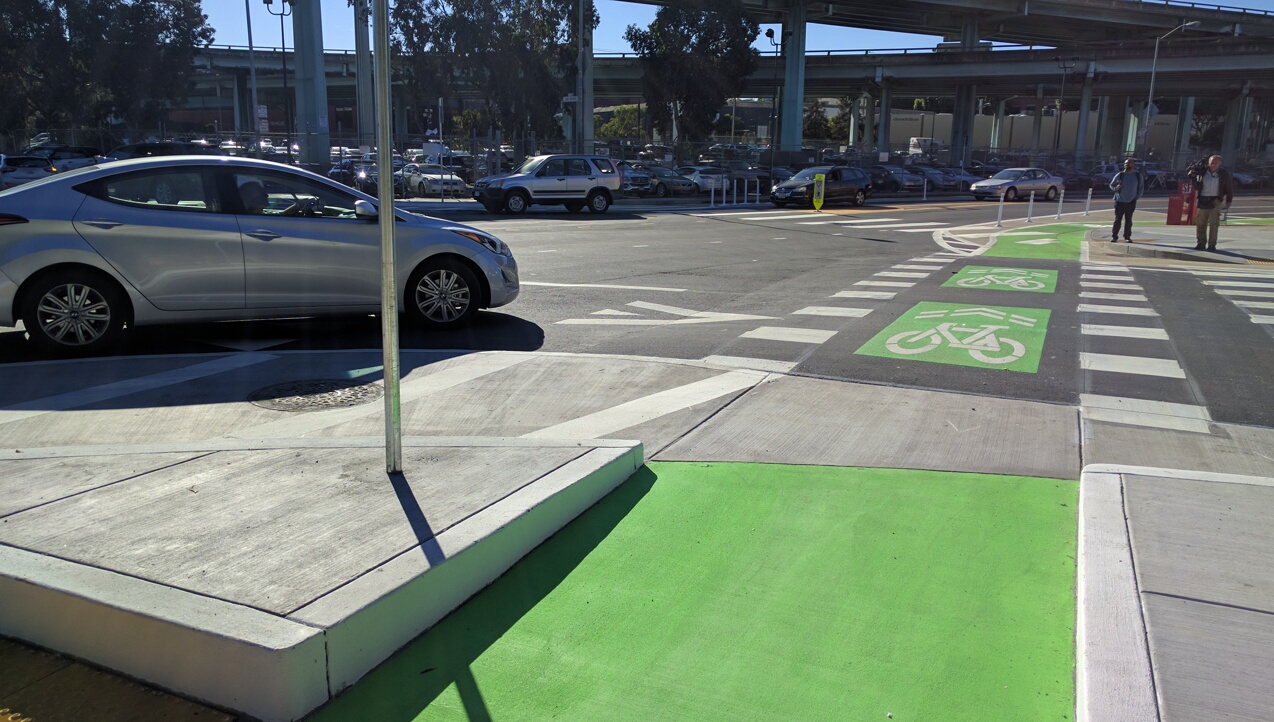 Cars slowed before crossing the bike lane and crosswalk, turning right onto 9th from Division. Photo: Streetsblog
