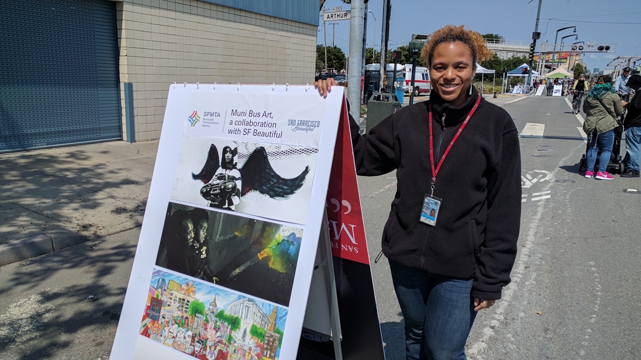 Adrienne Heim with a display from the Muni Art program.