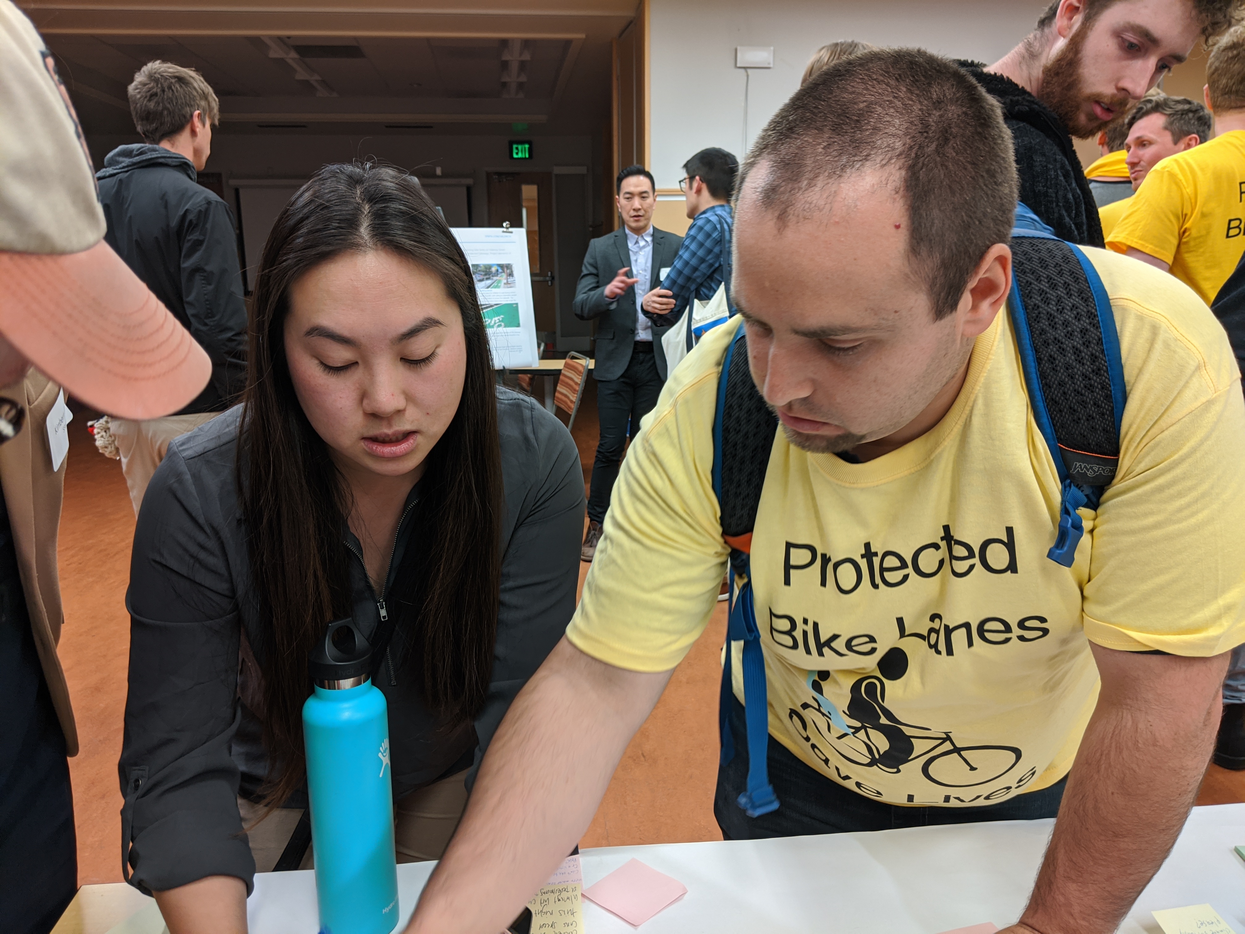 SFMTA engineer Winnie Lee and advocate Bruce Halperin discussing protected intersections at yesterday's open house. Photo: Streetsblog/Rudick