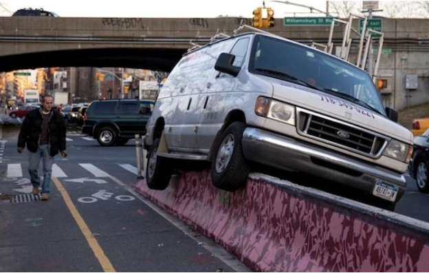 From Streetsblog NYC. A concrete barrier protected bike lane stopped this motorist from endangering cyclists on Flushing Avenue just west of the Brooklyn Queens Expressway. That's a fact. Photo: Dmitry Gudkov