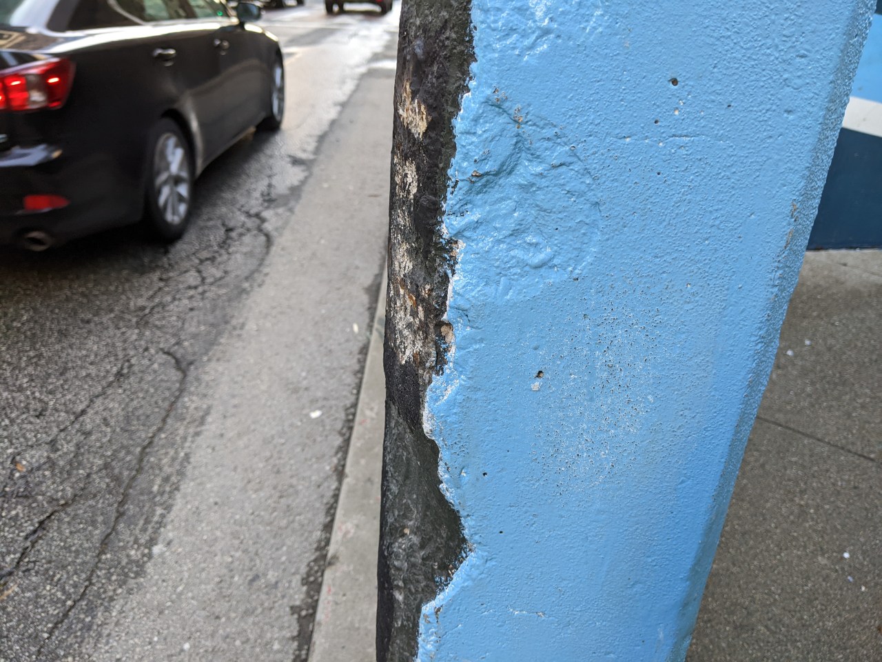 The walls around the plaza are pot-marked from years of motorists slipping them. But somehow paint and plastic is enough to protect cyclists?